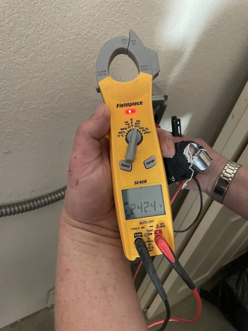 Voltage testing with clamp meter during Outlet Installation in Blanchard